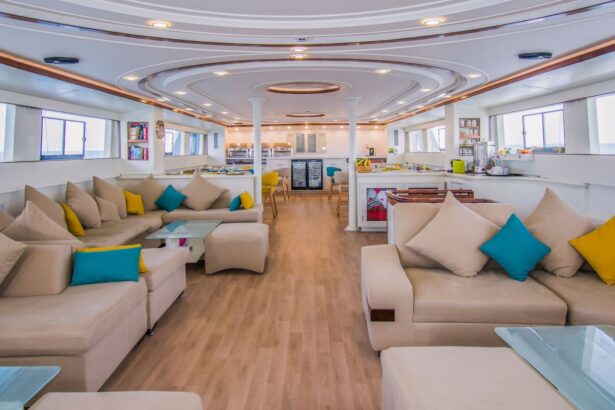 Spacious lounge with cream sofas and teal cushions aboard the yacht