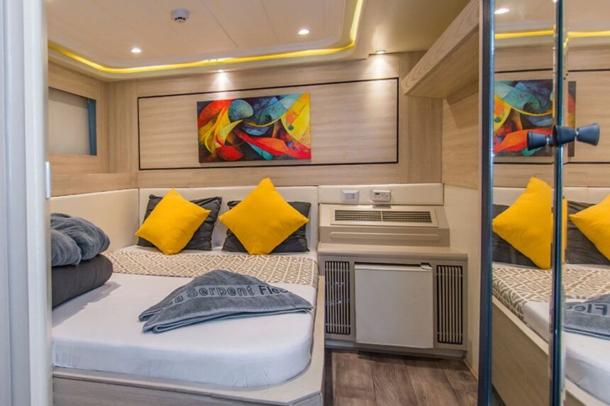 Cabin bed with yellow pillows and a colorful abstract painting on the wall