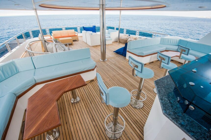 Upper deck lounge with white sofas overlooking the sea
