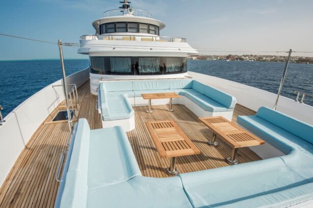 Light blue cushioned lounge seating on the yacht's bow deck