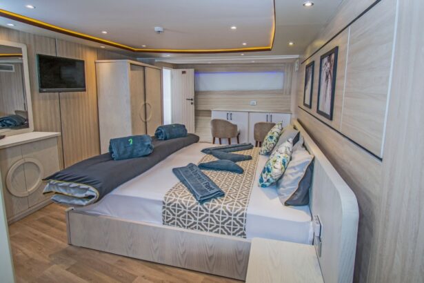 Cabin bed facing a wall mounted television and wardrobe
