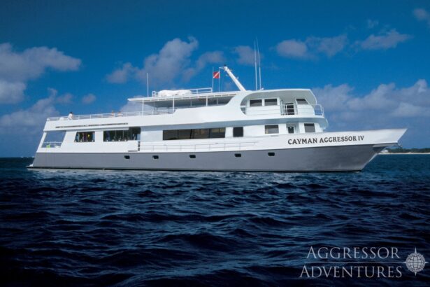 The Cayman Aggressor IV liveaboard cruising under a partly cloudy sky