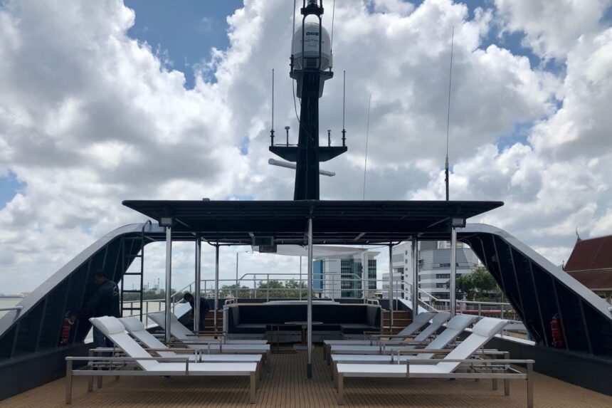 Rooftop sundeck of the All Star Velocean with sun loungers and a communications mast