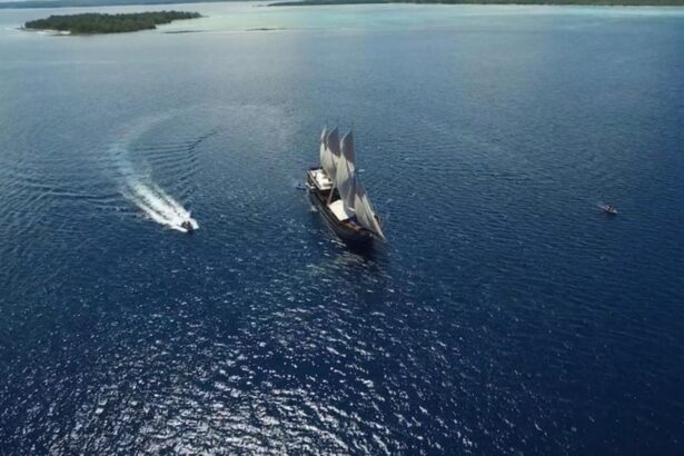 aerial view of the Amira liveaboard under sail with a tender boat alongside