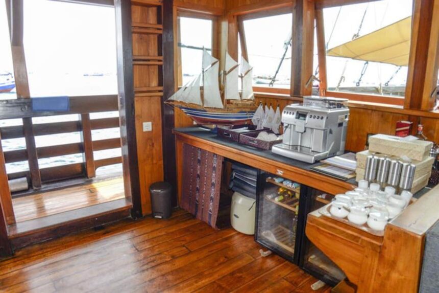 bar area aboard the Amira with a model sailboat and espresso machine