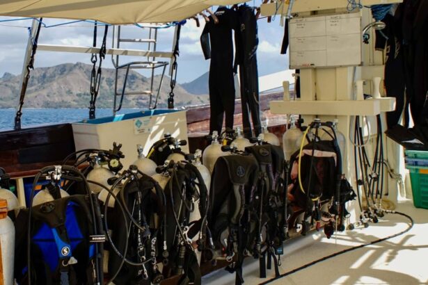 Rows of scuba tanks and wetsuits hanging on the Aurora's dive deck