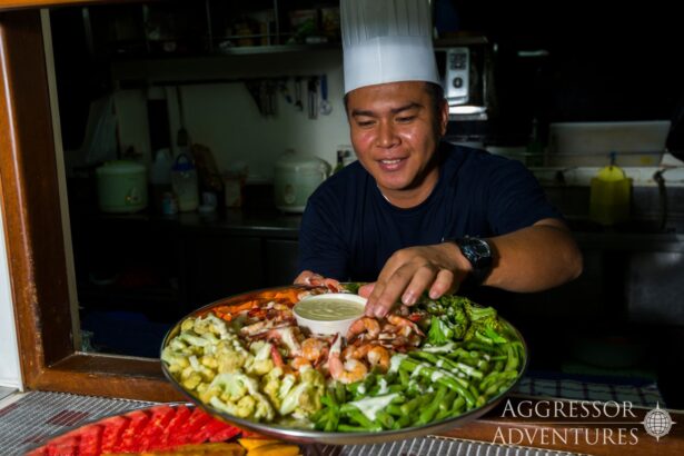 The ship's chef arranges a seafood and vegetable platter in the galley