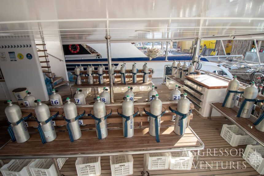 Rows of scuba tanks lined up on the dive deck of the Red Sea Aggressor IV