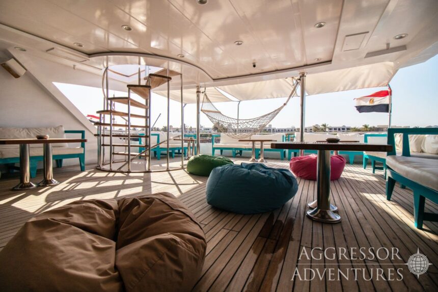 Sun deck with cushioned lounge seating and a hammock aboard the Red Sea Aggressor IV