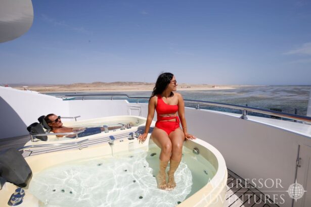 Two guests relax in a rooftop hot tub aboard the Red Sea Aggressor IV