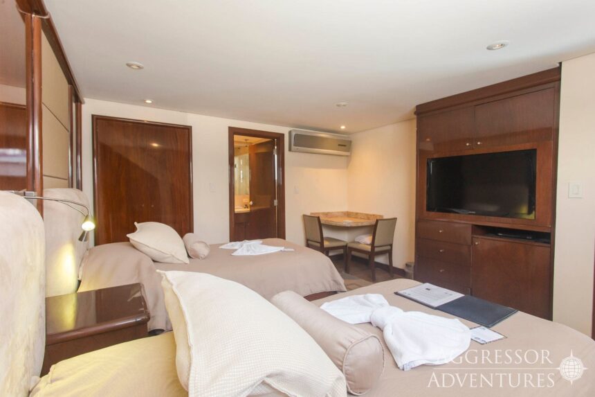 Twin beds with towel swans in an Okeanos Aggressor II cabin