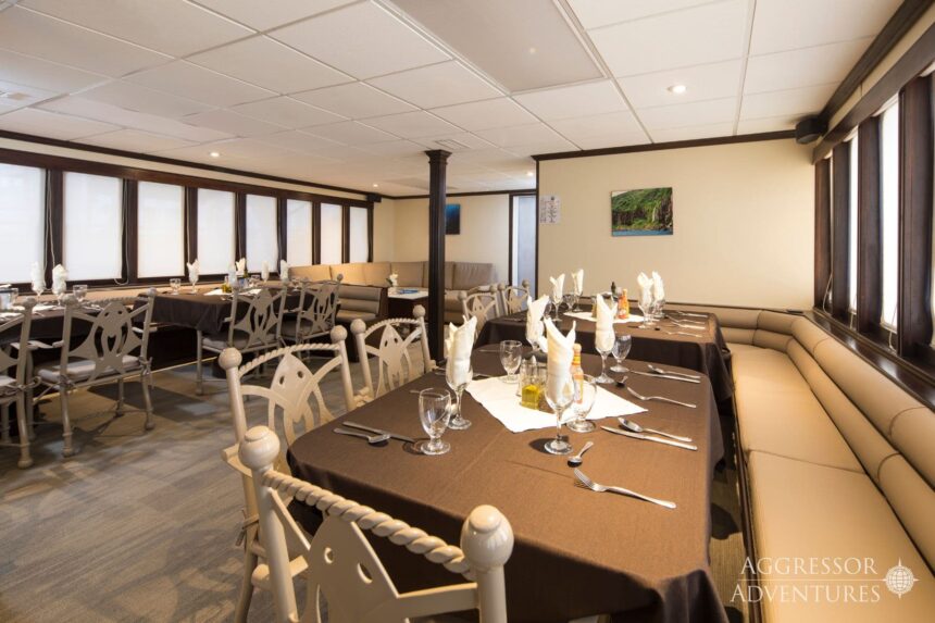 Formally set dining tables in the Okeanos Aggressor II restaurant