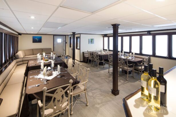 Dining room set with wine and place settings on the Okeanos Aggressor II