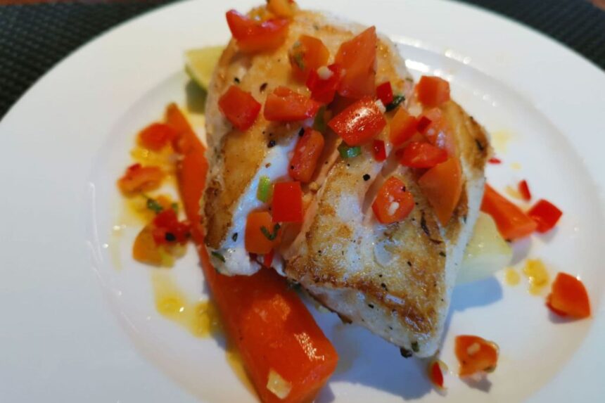 Seared fish fillet plated with diced tomato salsa aboard the Gaia Love