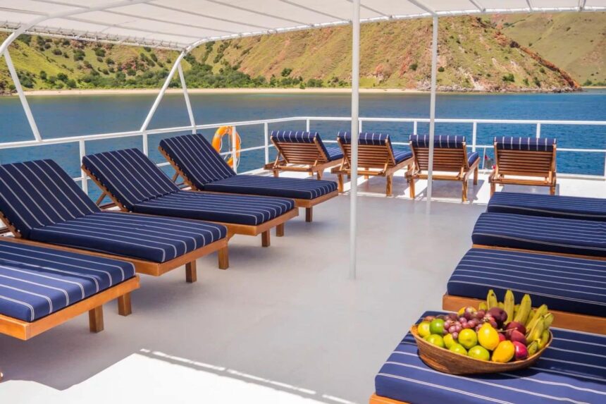 Rows of sun loungers on the Mermaid I sundeck overlooking a hillside bay