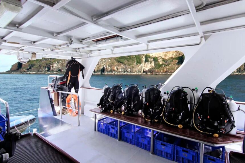 Scuba tanks and gear lined up on the dive deck of the Mermaid I