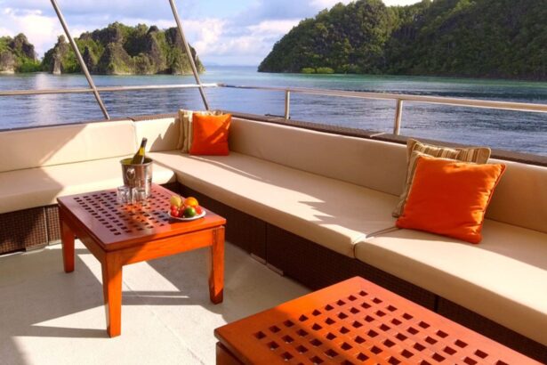 Small wooden table on the Mermaid II deck with a wine cooler and fruit plate