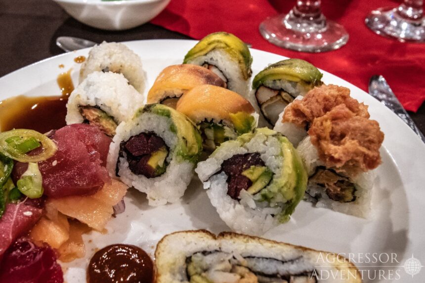 Sushi platter with tuna, salmon and assorted rolls served on board