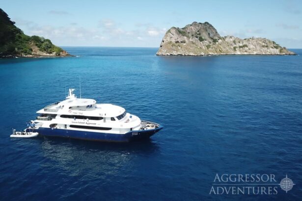 Aerial view of the Cocos Island Aggressor anchored near a rocky islet