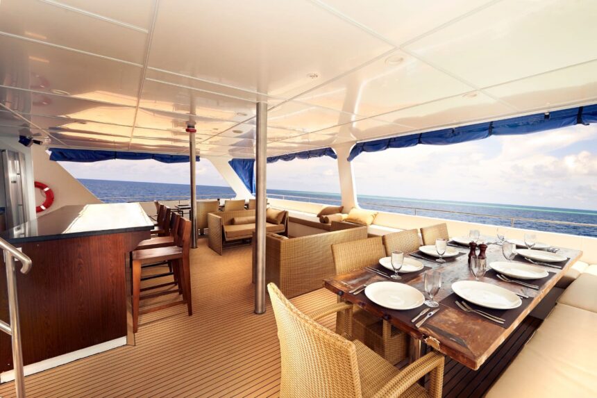Covered outdoor dining and lounge area on the aft deck of the Blue Manta