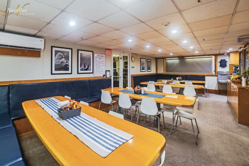 Dining room set with tables aboard the Nautilus Belle Amie