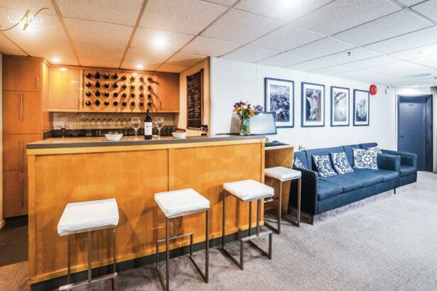 Wooden bar with wine bottles and stools aboard the Nautilus Belle Amie