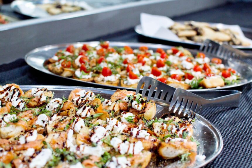 Trays of bruschetta appetizers with tomato and goat cheese on the buffet