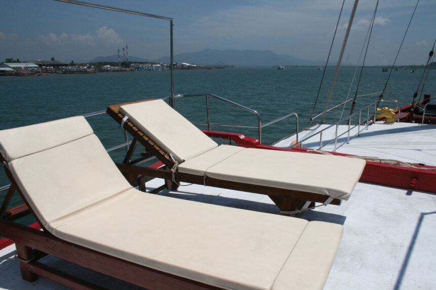 Cushioned lounge chairs on The Junk's sundeck overlooking the harbor