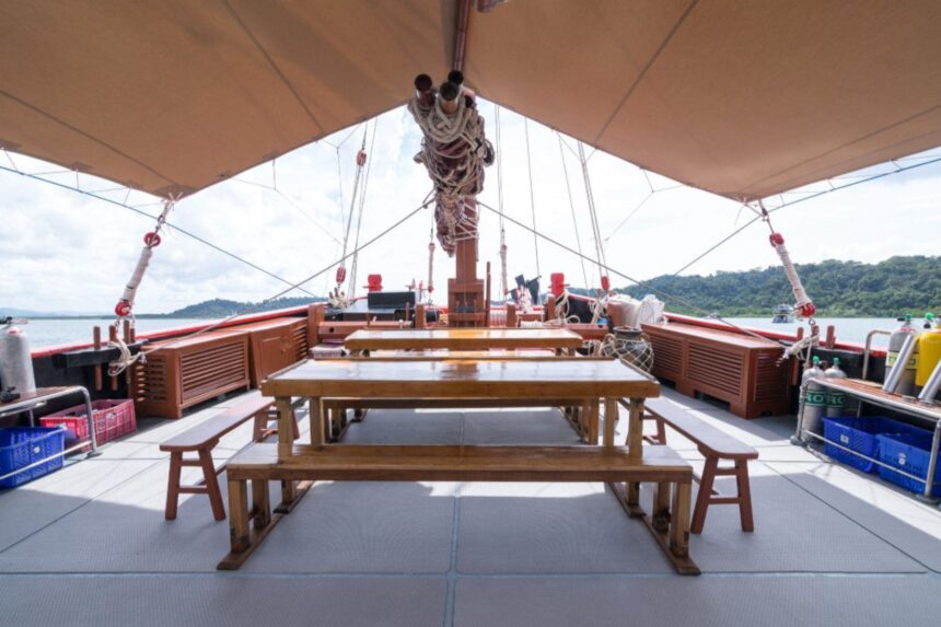 Dining tables and benches set up on The Junk's open deck
