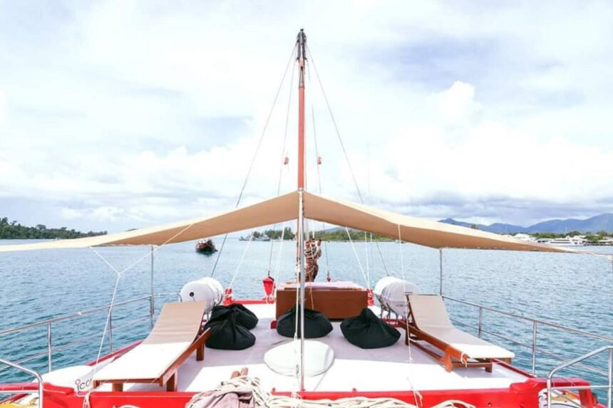 Shaded bow deck of The Junk with lounge chairs and rigging