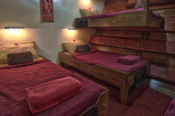 Cabin with red-covered bunk beds aboard The Junk