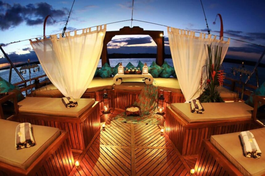 Curtained daybeds and lanterns on the Arenui's deck at night