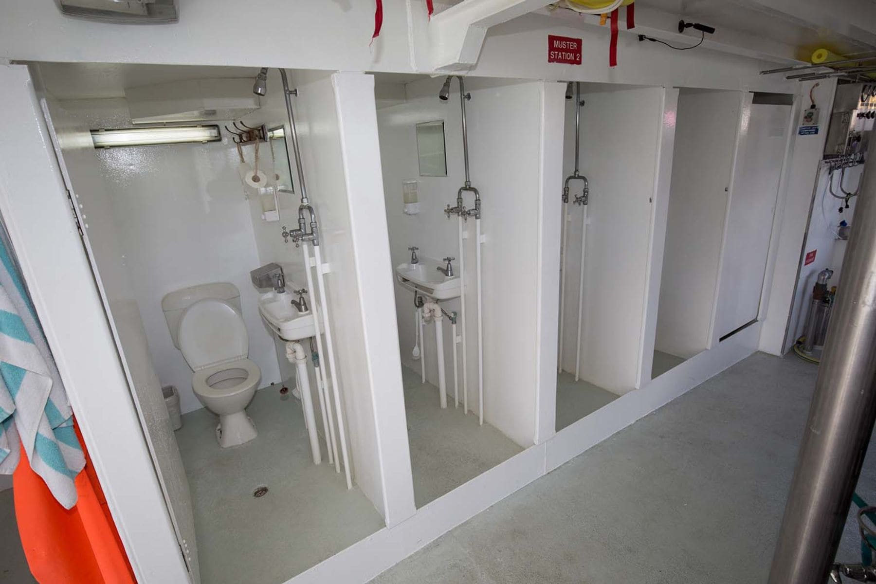 Shared bathroom and shower stalls aboard the Pacific Master