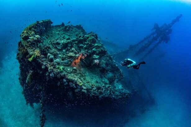 Diver's light illuminating a sunken ship's stern in Truk Lagoon