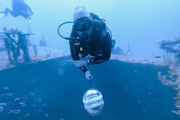 DIVEIN tester filming with the Insta360 X3 on a selfie stick while hovering over a wreck