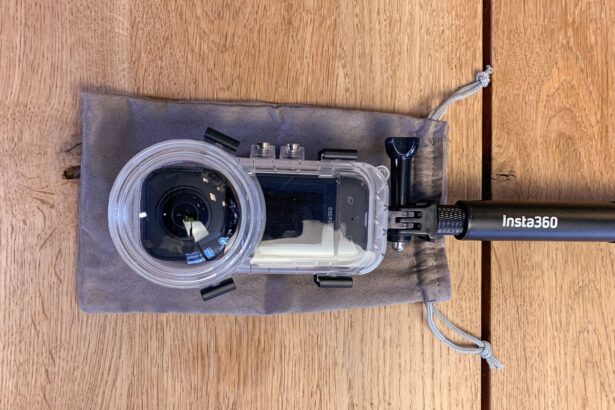 Insta360 X3 Invisible Dive Case resting on its grey drawstring pouch next to the branded selfie stick