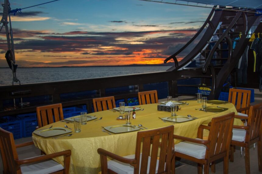 Sunset view from the dining table on the Dewi Nusantara's outer deck
