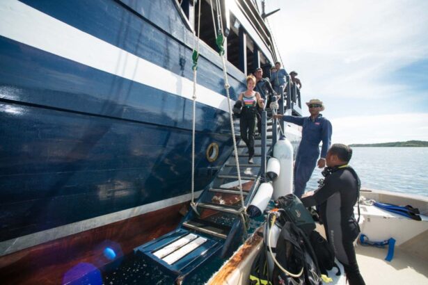 Divers climbing the boarding ladder back onto the Dewi Nusantara after a dive