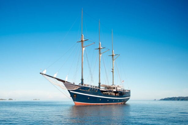 The Dewi Nusantara wooden liveaboard schooner anchored on calm blue water