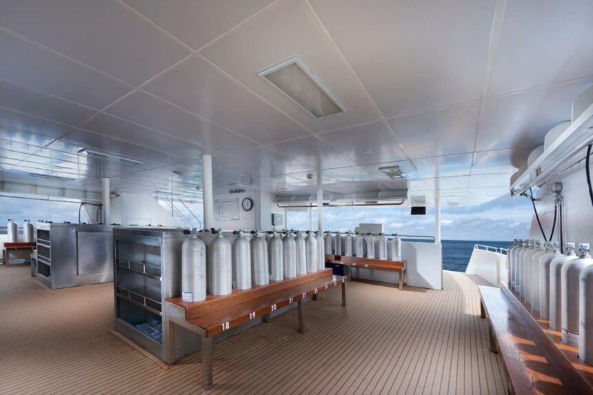 Dive tank storage area with numbered benches on the White Manta's dive deck