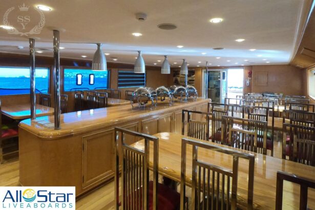 onboard dining room with polished wood tables and chairs set for service