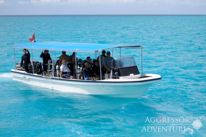 Divers riding a dive skiff across turquoise water near Palau