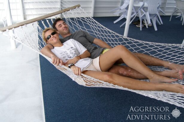 Couple relaxing together in a hammock on the sundeck of the Palau Aggressor II