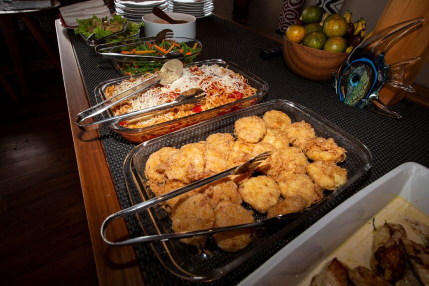 Buffet spread of salad, pasta, and fried appetizers aboard the Coralia