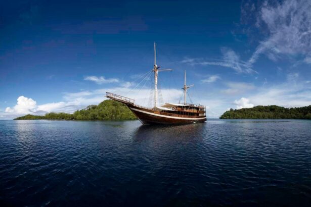 The Coralia liveaboard under full sail on calm open water