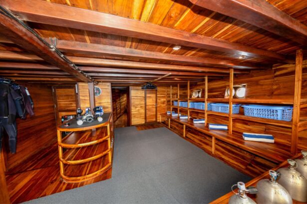Wood lined dive deck with tanks and gear baskets aboard the Coralia