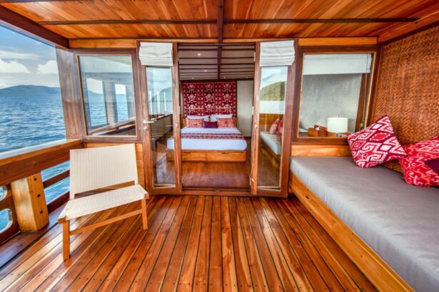 Wood paneled cabin aboard the Coralia with a private balcony deck