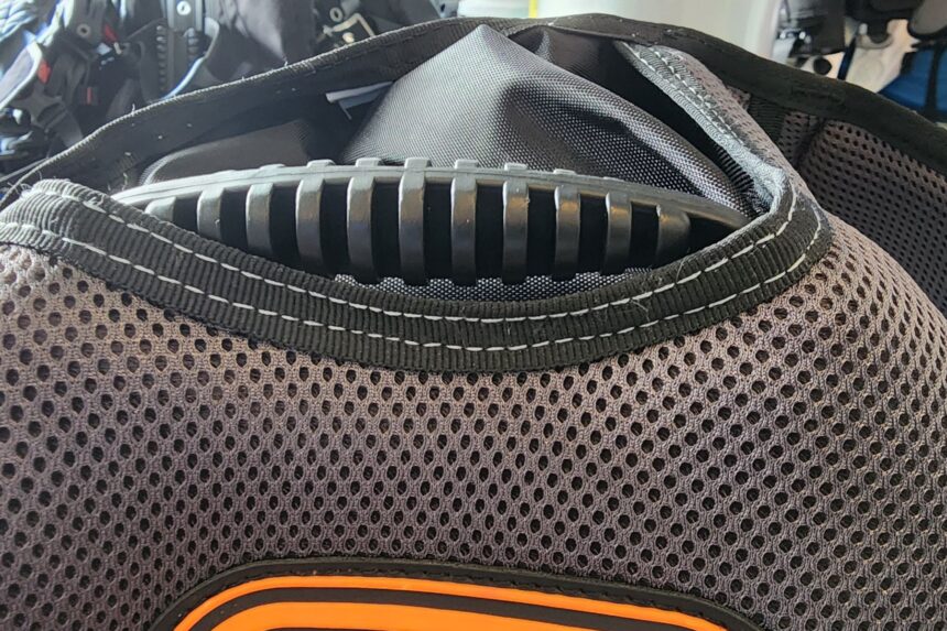 Close-up of a ribbed plastic panel tucked into the padded mesh back of the SEAC EQ-Pro BCD