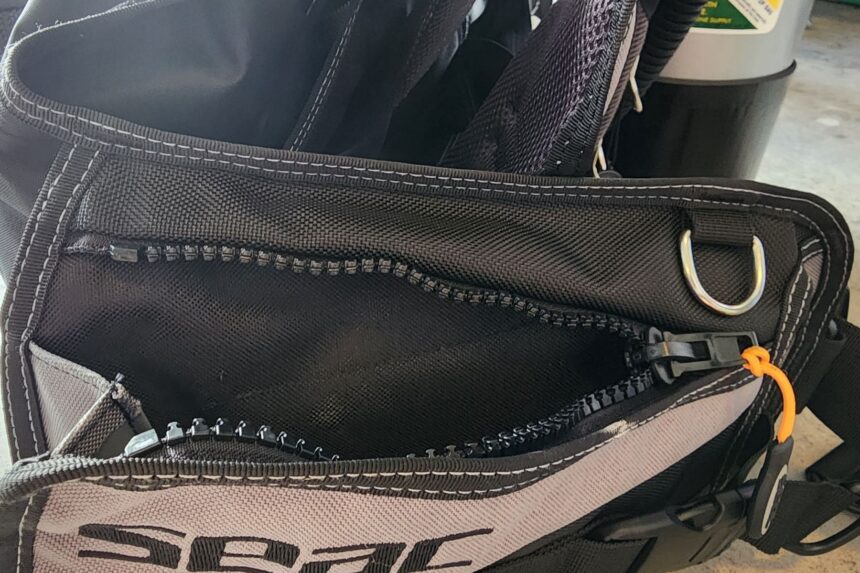 Zippered expanding pocket on the side of the SEAC EQ-Pro BCD with a D-ring mounted above it
