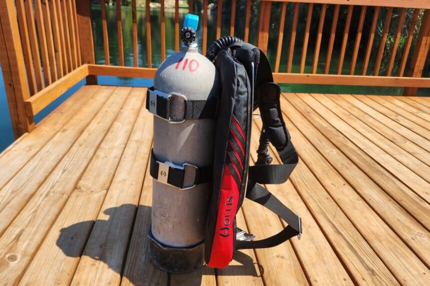 Hollis STS wing and backplate strapped to an aluminum tank on a wooden dock, side view